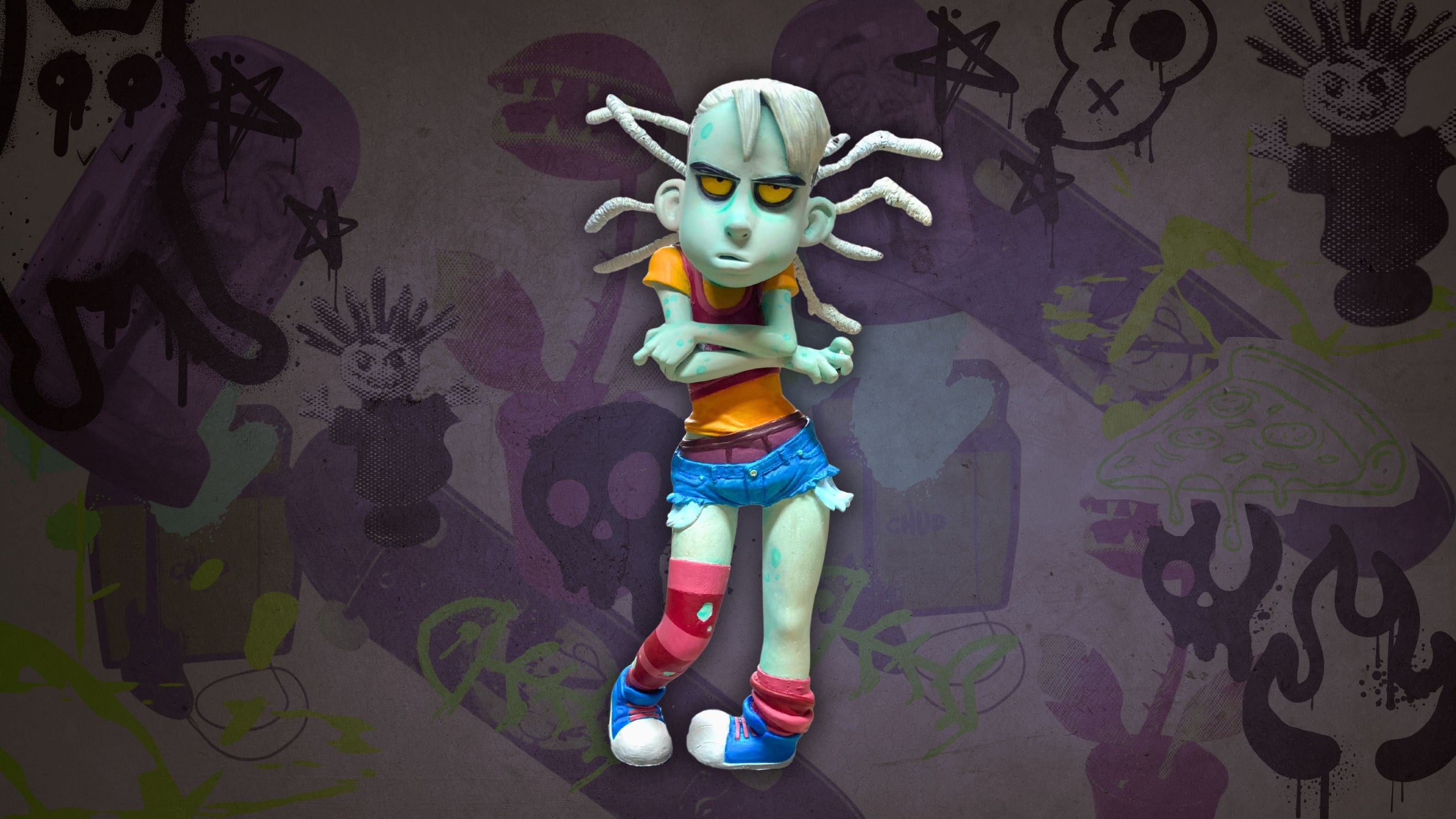 Zoé, a zombie puppet with white dreadlocks, arms crossed in front of a purple graffiti wall